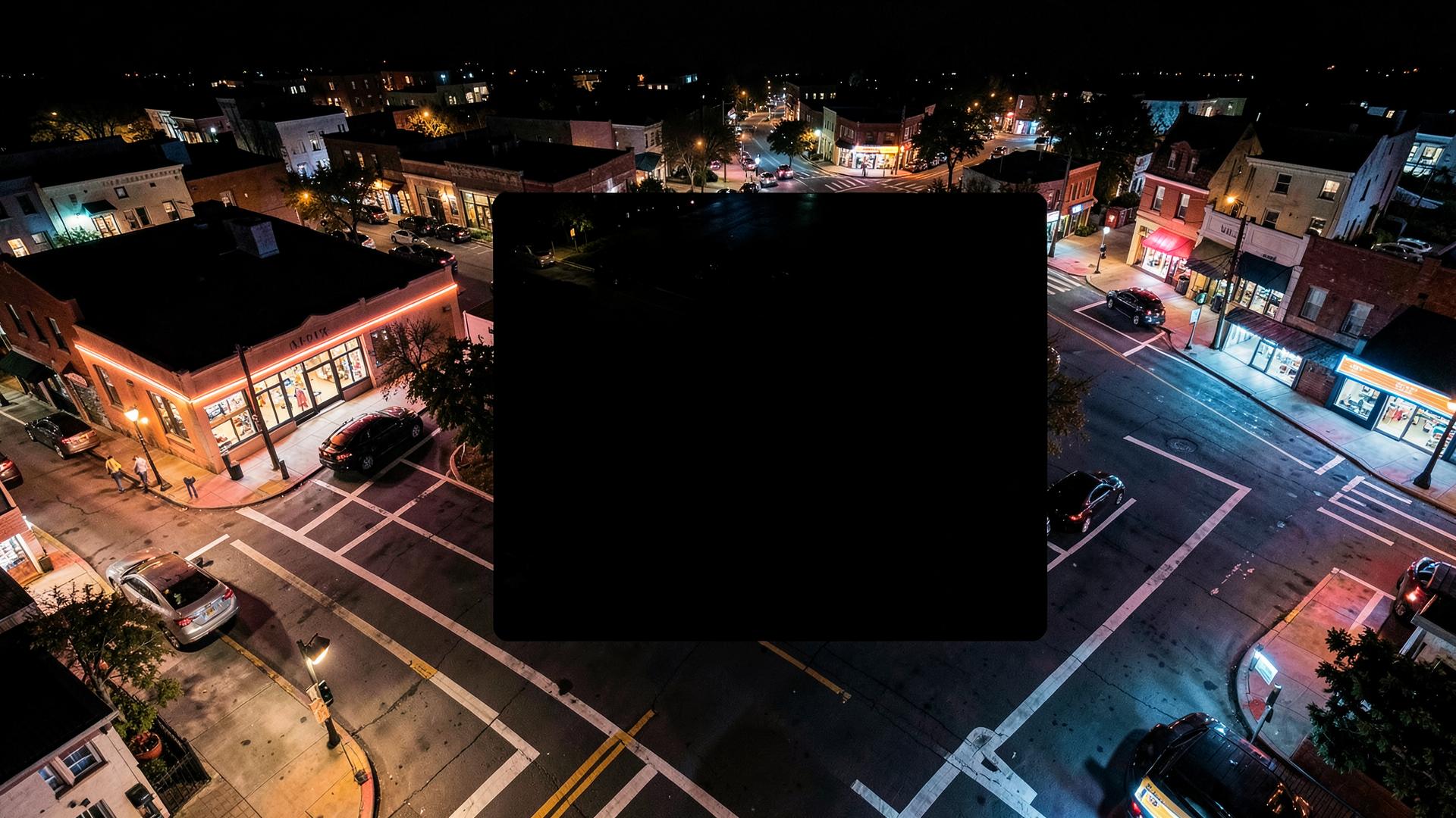 Local businesses illuminated along a busy main street